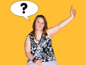 A woman with long hair is sitting and raising her right hand, and a speech bubble with a question mark above her head shows she wants to ask a question.