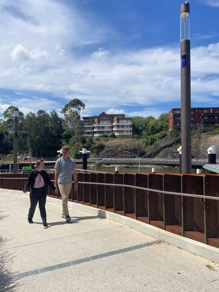 Two people walking together near the waterfront
