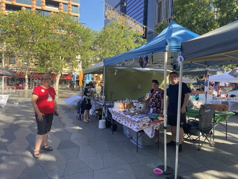 People visiting stalls at an outdoor community market
