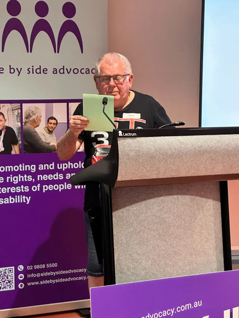 Man speaking at a Side By Side Advocacy event