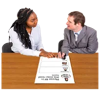Two people discussing documents at a table