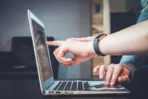 People reviewing information together on a laptop